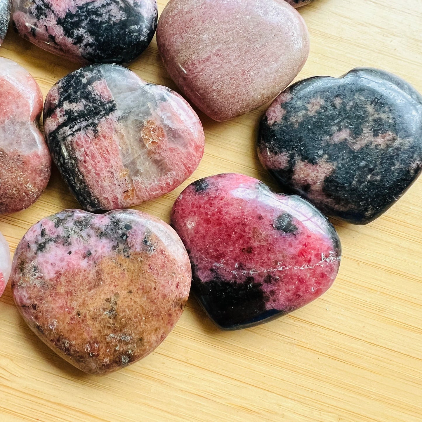 Top-down shot of Rhodonite polished heart, kept near for Emotional Healing, from Atsimo-Andrefana, Madagascar.