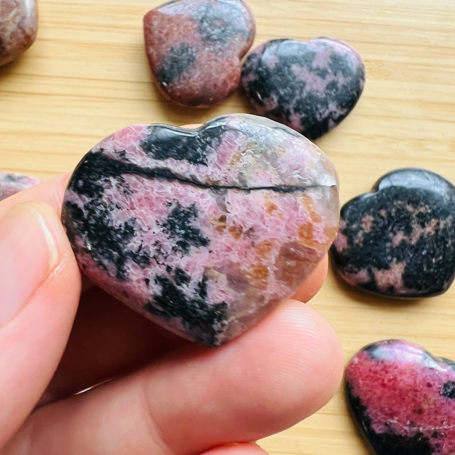 Back view of Grade AA Rhodonite heart showing natural surface