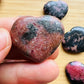 Detail shot of Grade AA Rhodonite heart under natural light