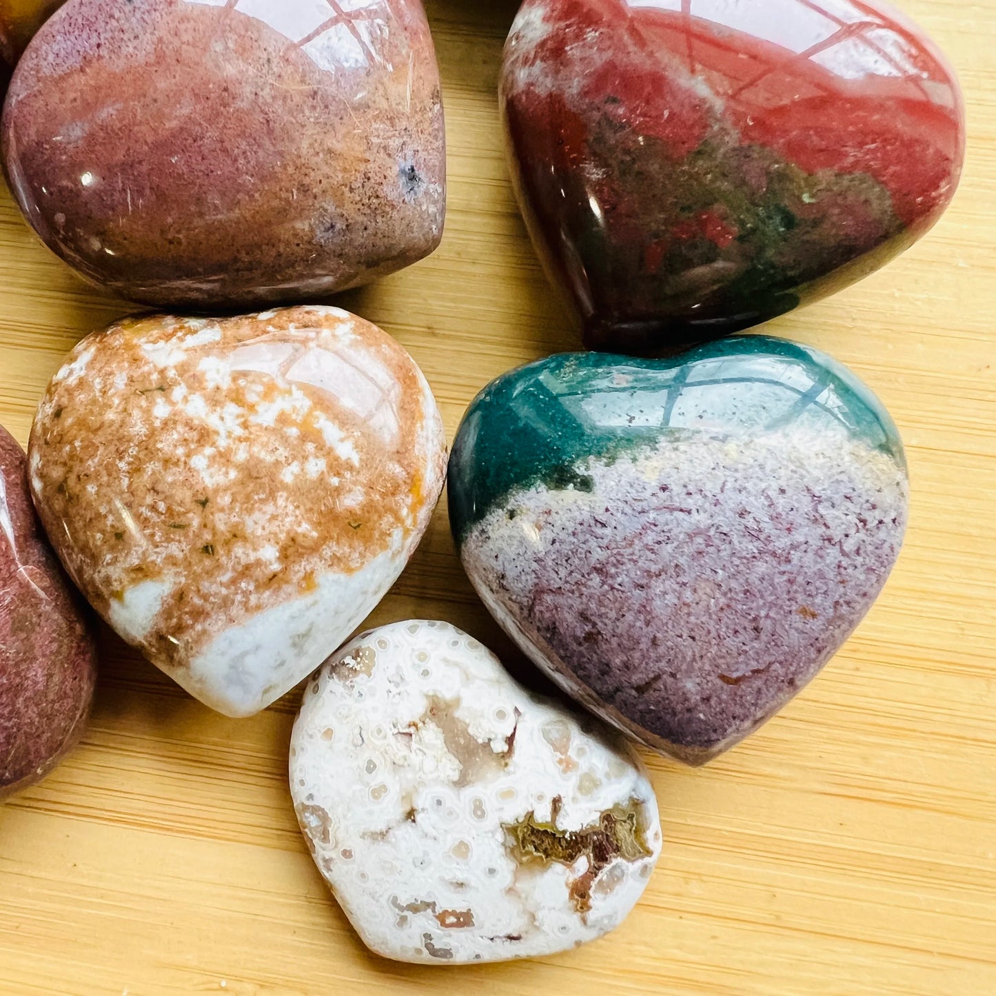 Close-up of Ocean Jasper heart carving from Madagascar, soothing wellness stone for Emotional Healing