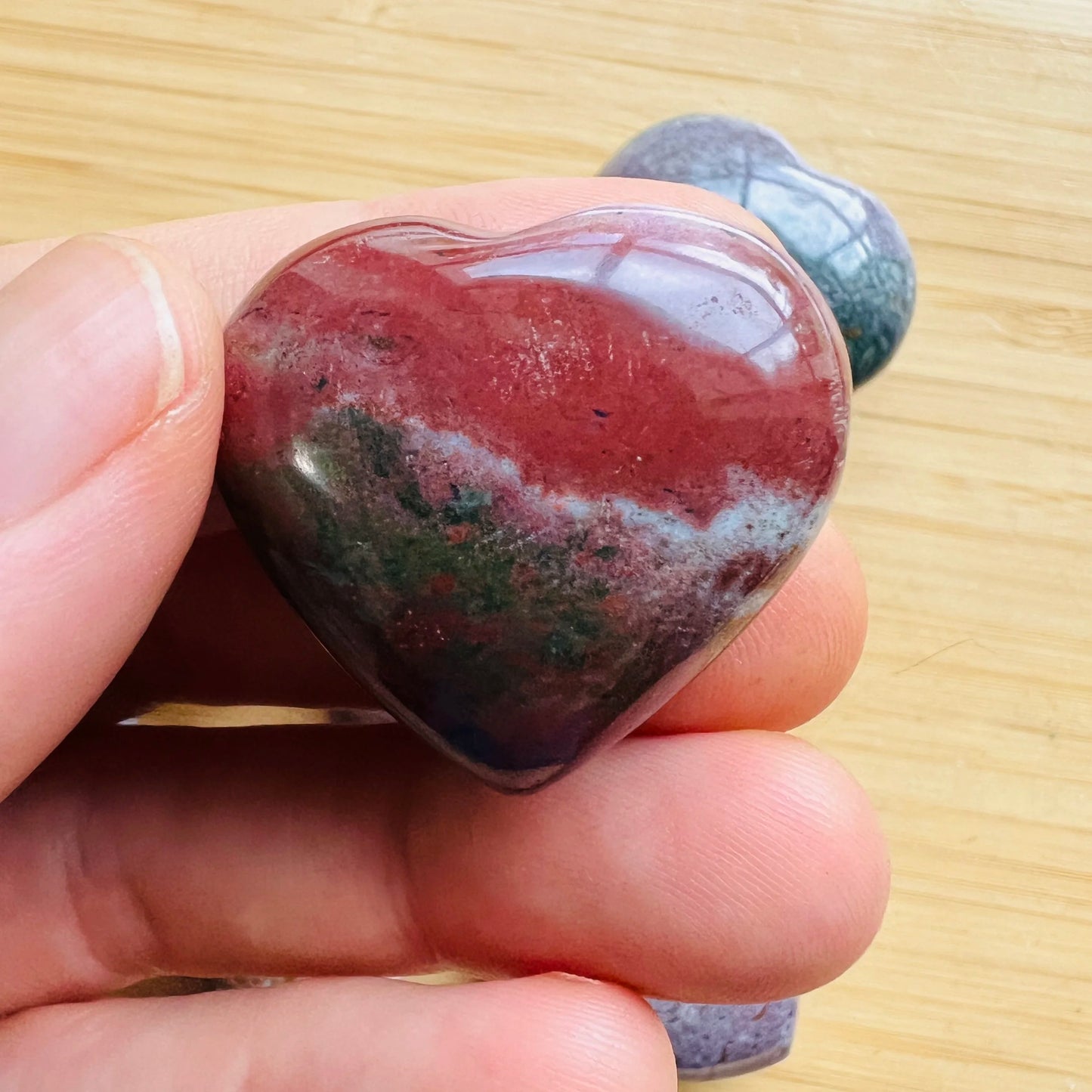 Close-up of Ocean Jasper heart carving from Madagascar, soothing wellness stone for Emotional Healing