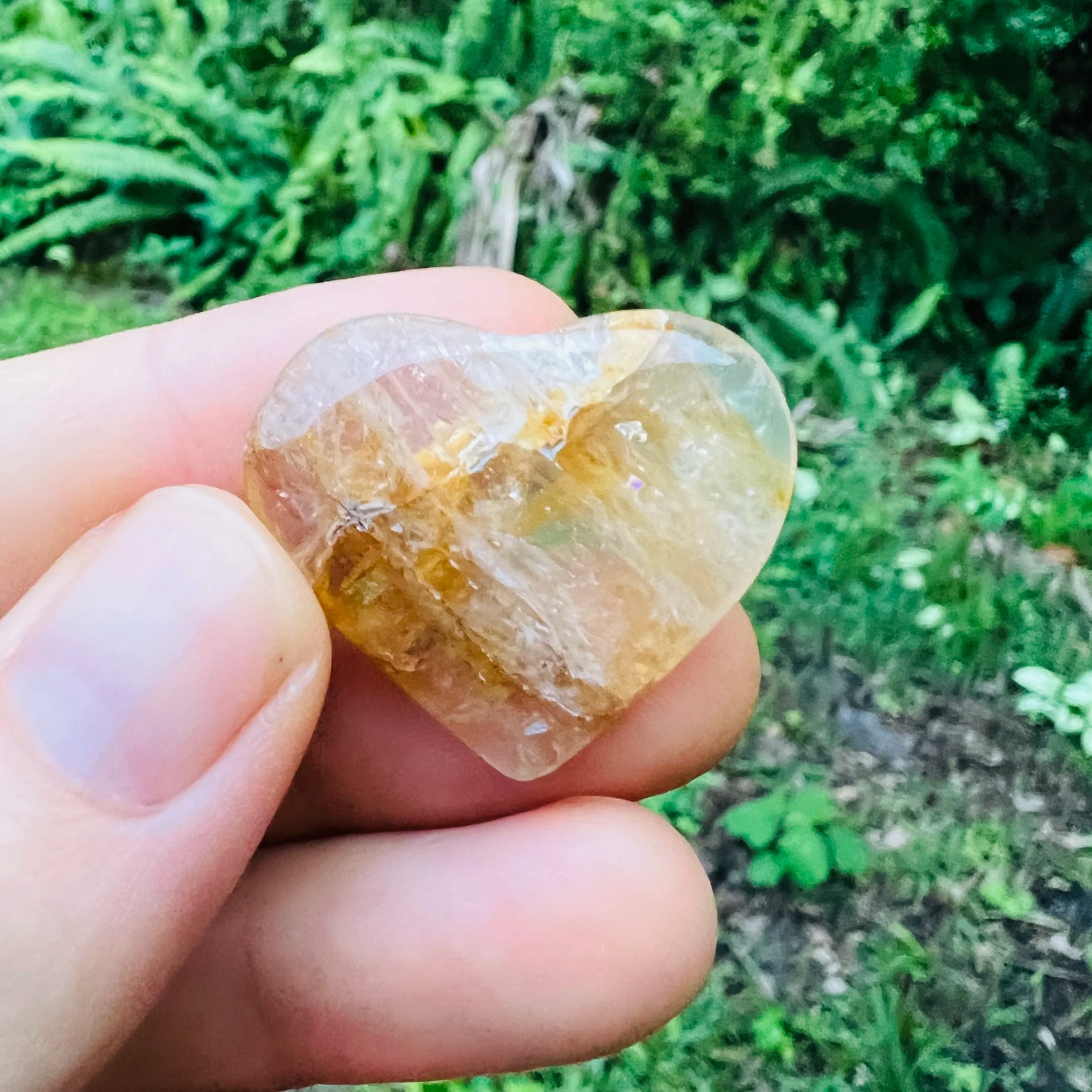 Side perspective of Golden Healer polished heart, for Healing and Meditation, sourced from Brazil.