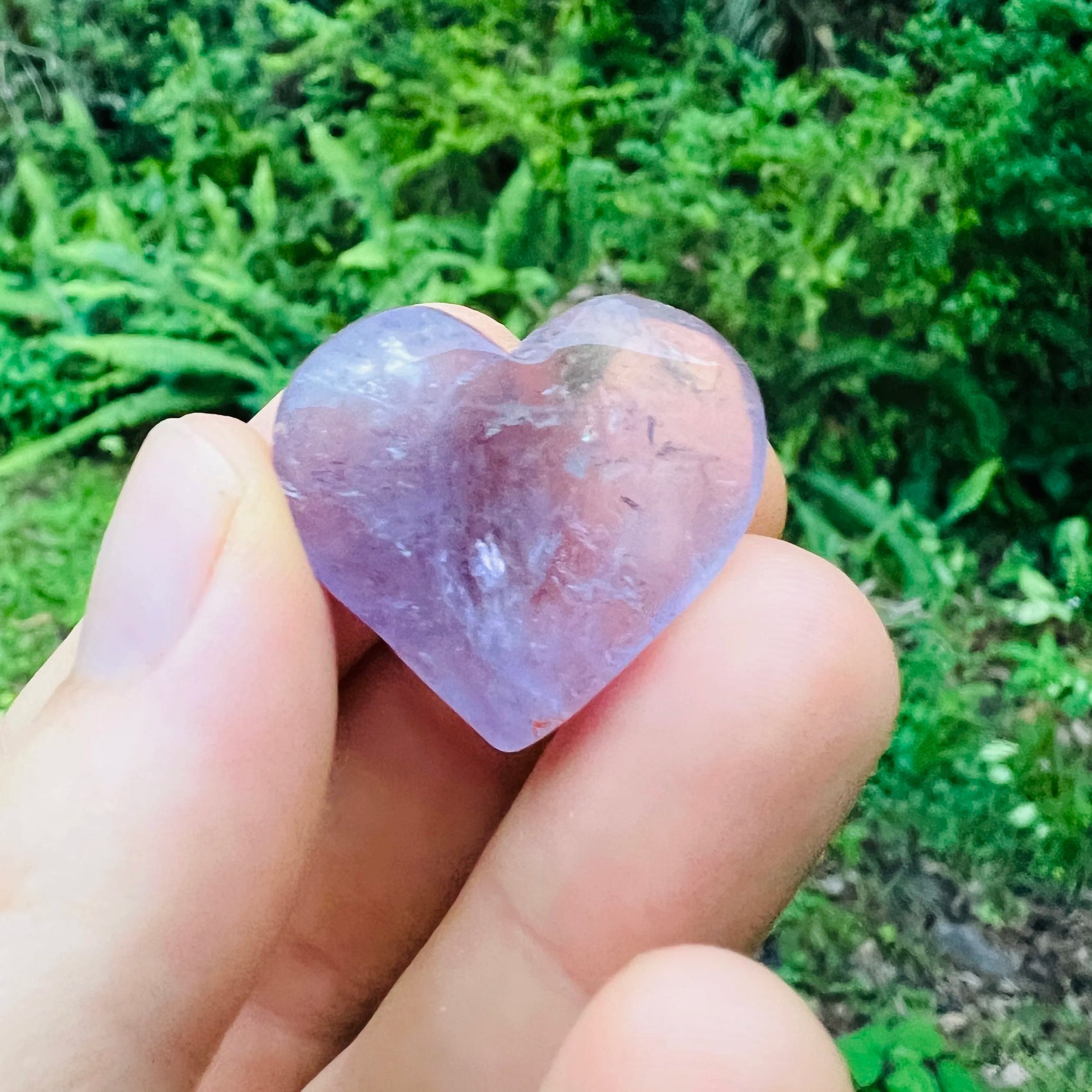 Side-on view of Amethyst polished heart, showing characteristic color, from Brazil.