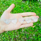 Near view of Clear Quartz polished heart, showing natural inclusions, kept close for Cleansing.