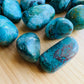Side angle of Chrysocolla tumbled stone, Peru-sourced.