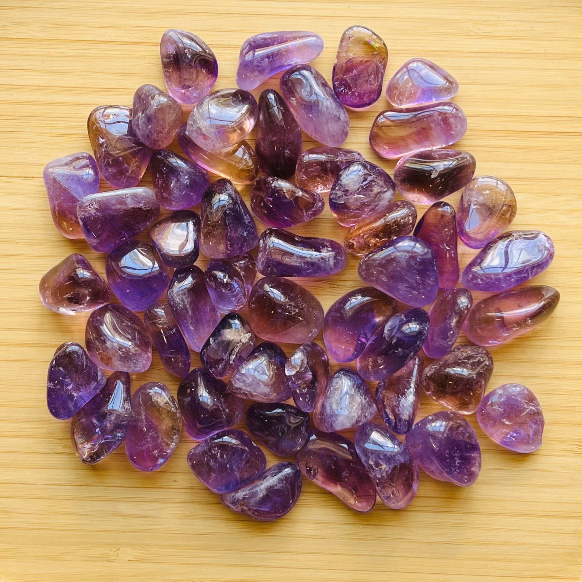 Detail shot of Grade AAA Ametrine tumbled stone under natural light