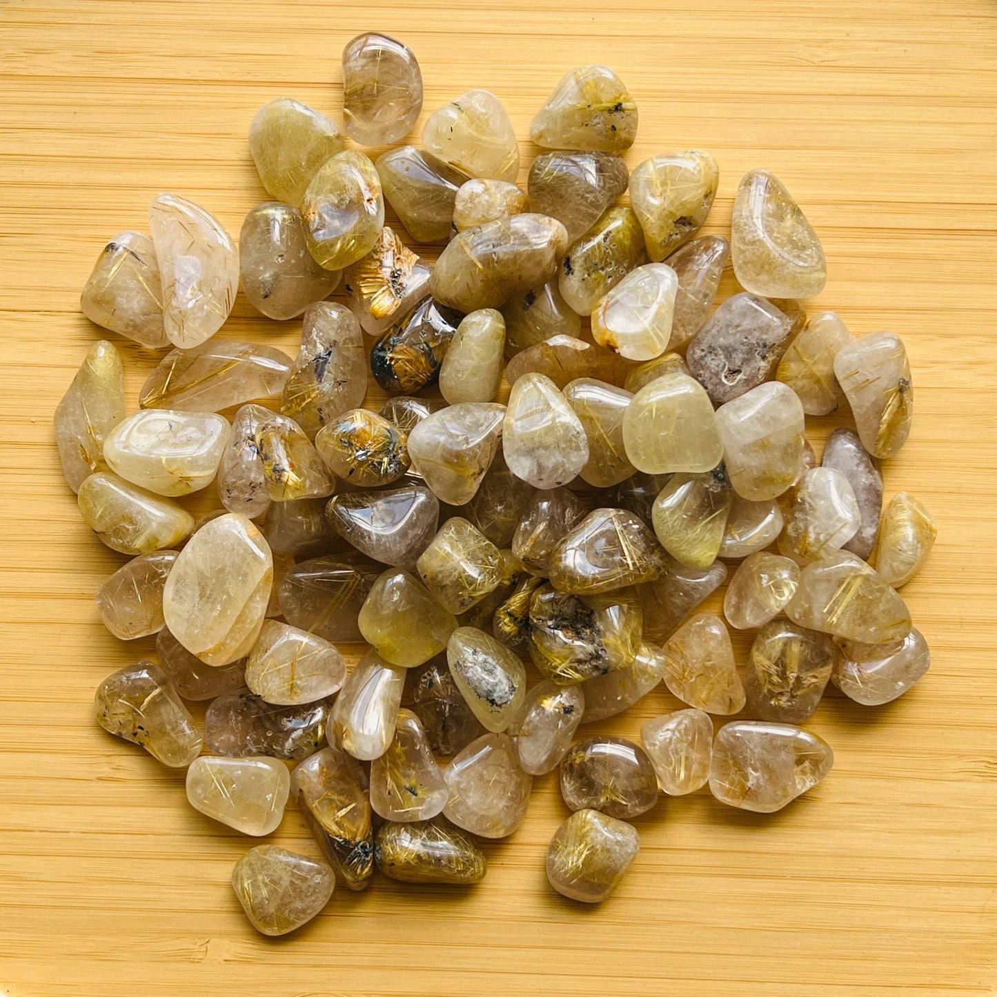 Considered view of Quartz tumbled stone, from Minas Gerais, Brazil, linked to Cleansing, shown alongside the hand for scale.