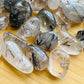 Side perspective of Quartz tumbled stone, for Cleansing and Meditation, showing soft luster.