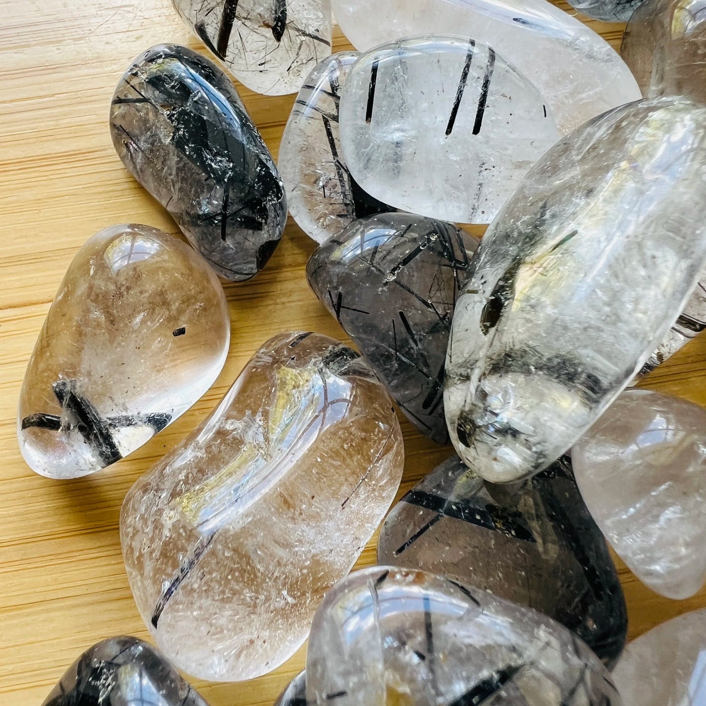 Lifestyle view of one Quartz tumbled stone for scale, from Brazil.