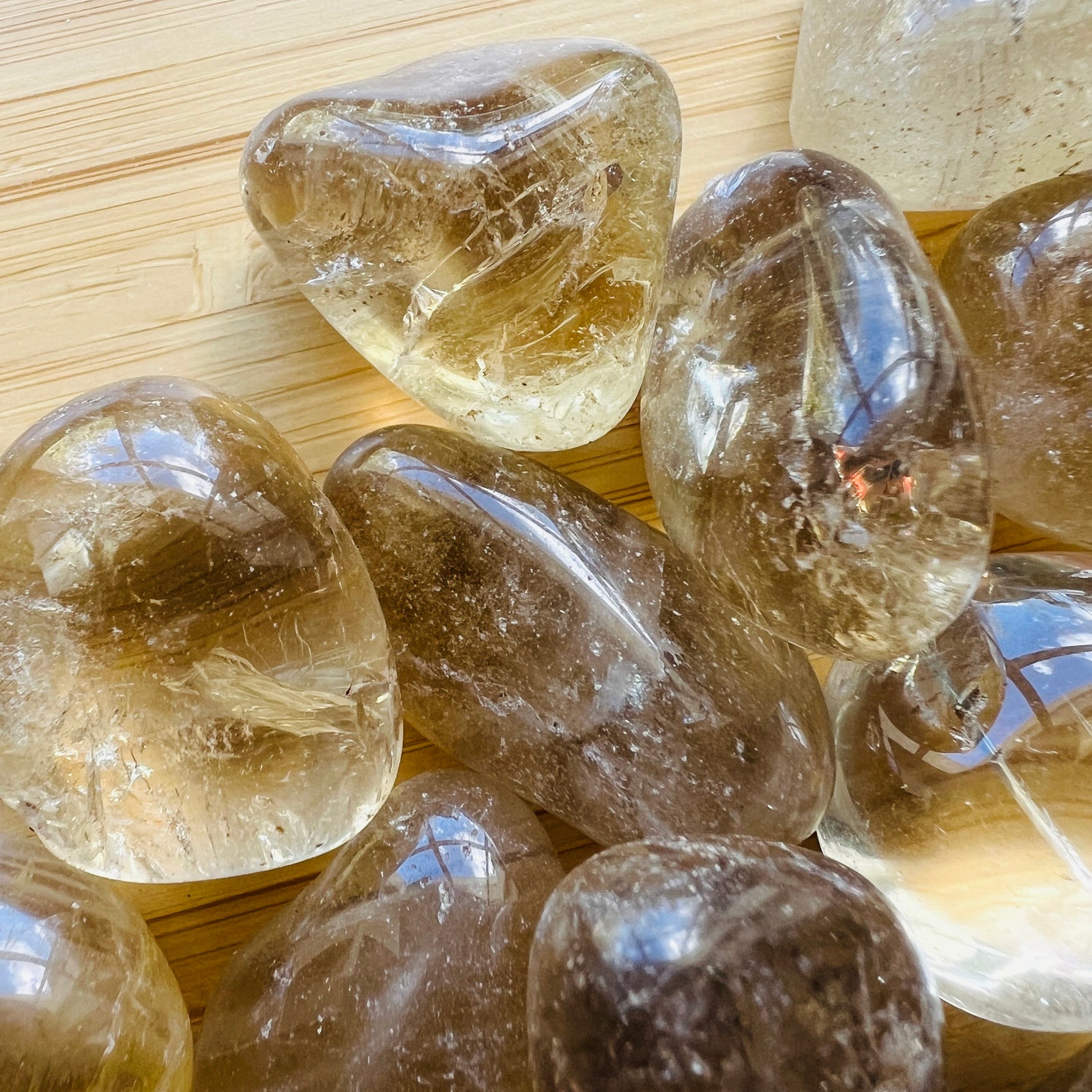 Size comparison with a single Natural Citrine tumbled stone Brazil-sourced, Brazil-sourced.