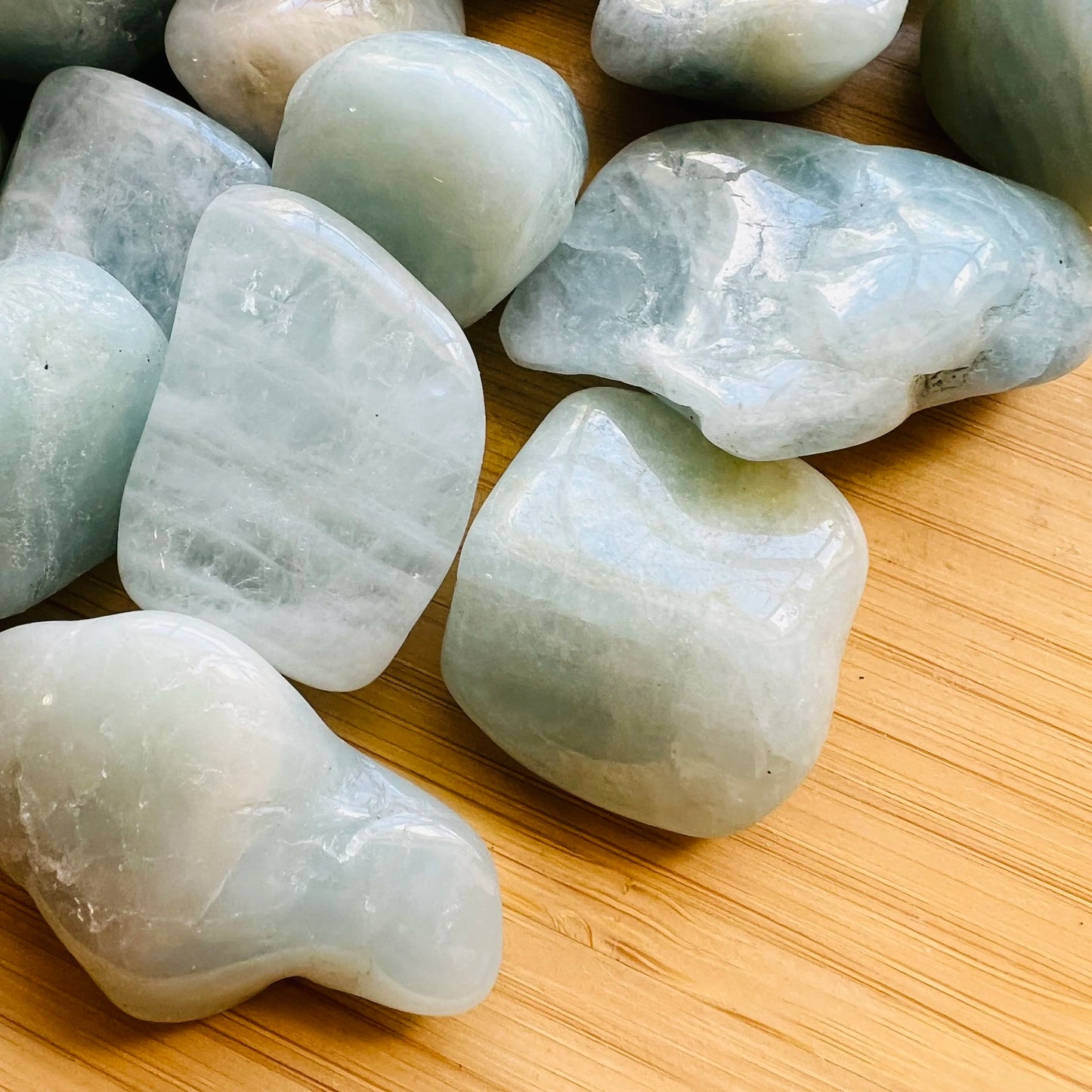 Natural light view of a Aquamarine tumbled stone kept near for Stress Relief.