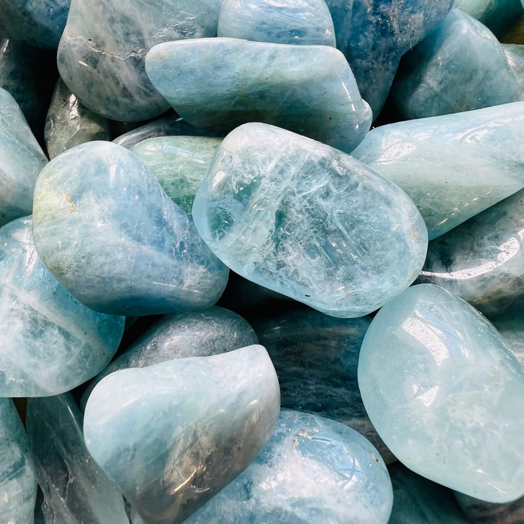 Detail capture of Grade AAA Aquamarine tumbled stone, hand-selected from Minas Gerais, Brazil.