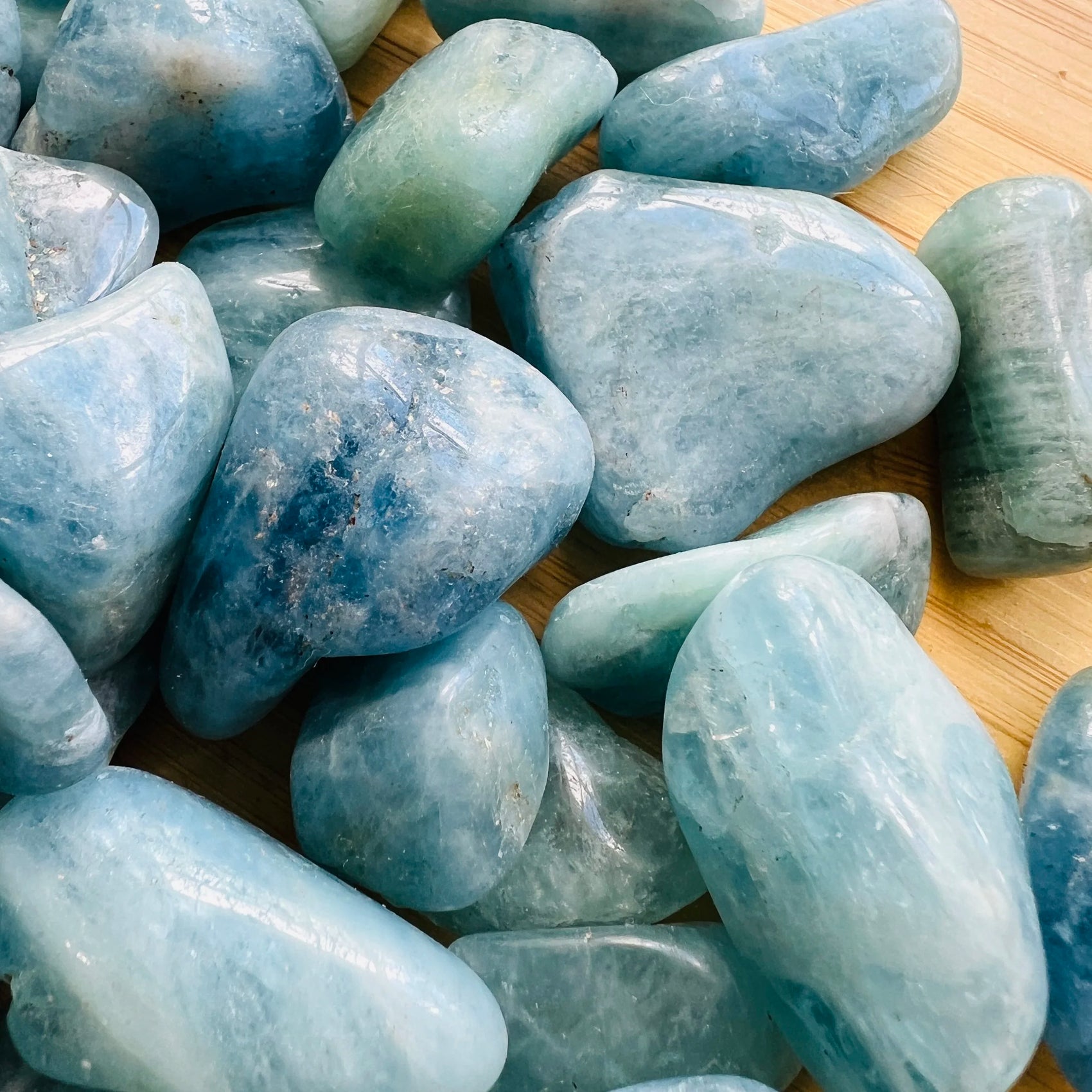 Top view of Aquamarine tumbled stone, sourced from Minas Gerais, Brazil, often worked with for Stress Relief.