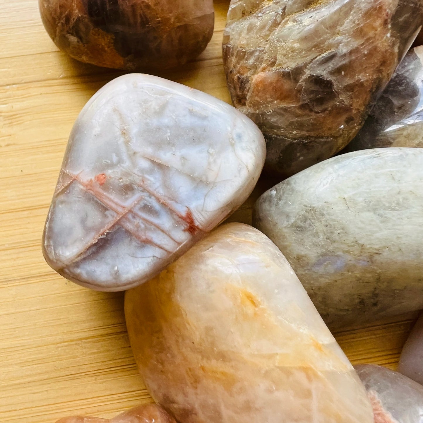 Daylight view of a single Earth Moonstone tumbled stone from Minas Gerais, Brazil.