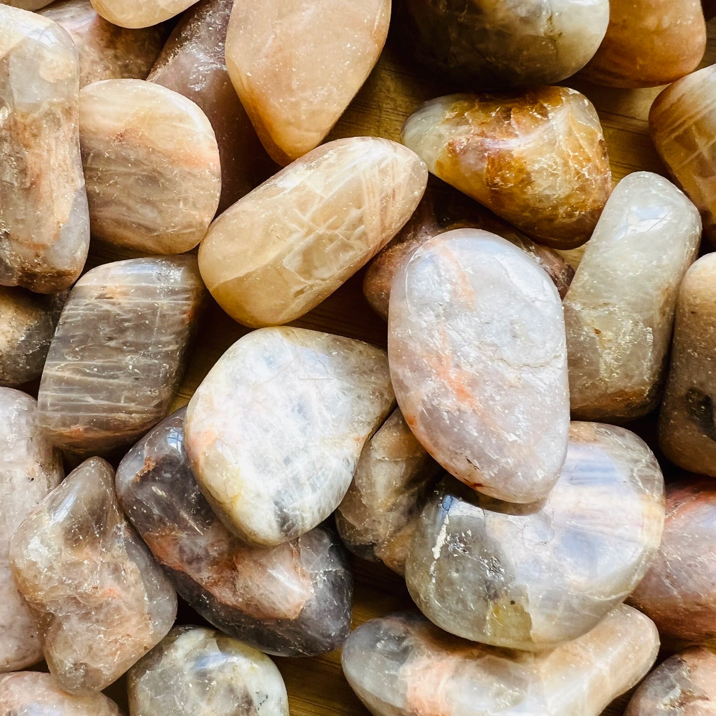 Side perspective of Grade AA Earth Moonstone tumbled stone, sourced from Minas Gerais, Brazil.