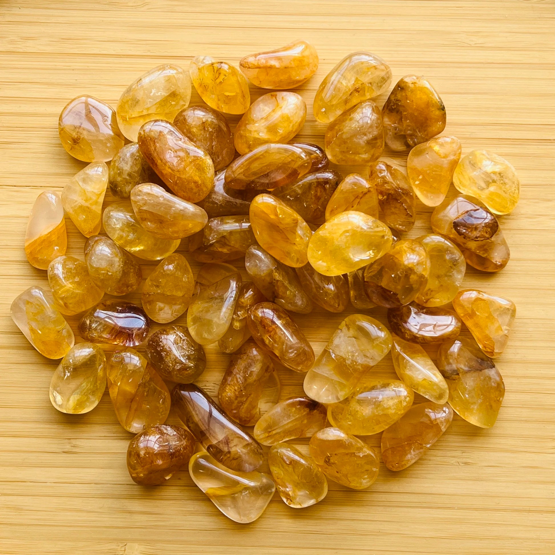 Companion image of Golden Healer tumbled stone, from Minas Gerais, Brazil, associated with Cleansing, set against a soft neutral surface.