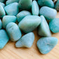 Edge view of Amazonite tumbled stone, sourced from Brazil.