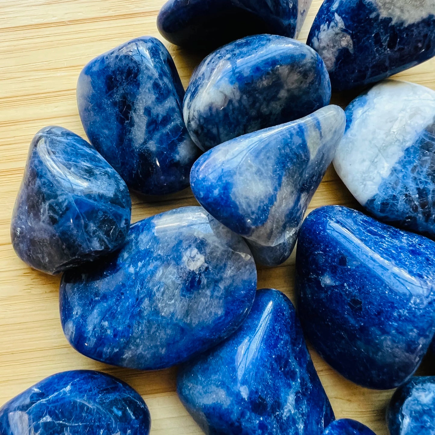 Overhead view of Grade A Sodalite tumbled stone, associated with Focus, showing characteristic color.