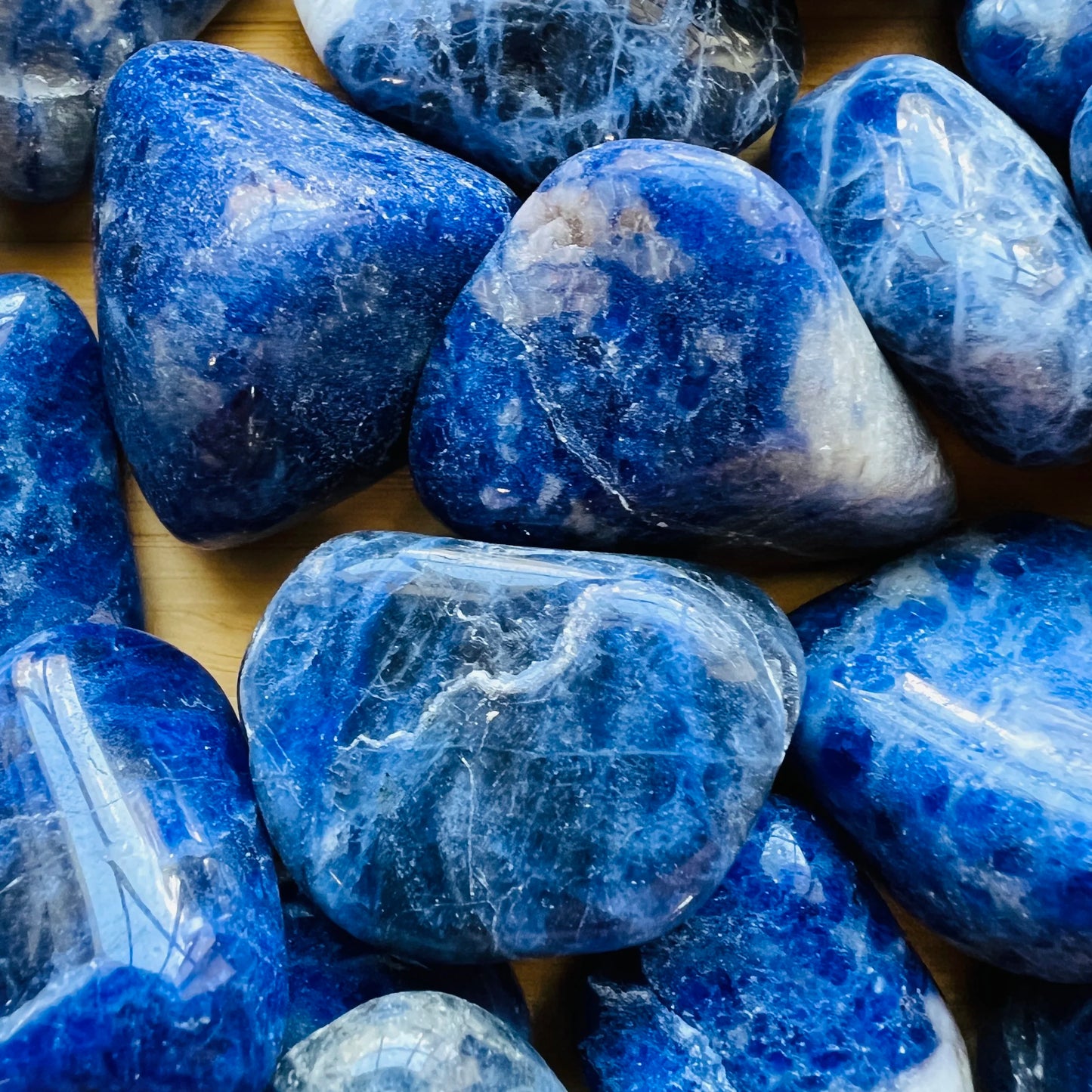 Reverse side of Sodalite tumbled stone, from Brazil, showing translucent edges.