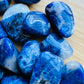 Hand-scale shot of a Sodalite tumbled stone, sourced from Brazil.