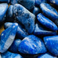 Underside detail of Sodalite tumbled stone, showing characteristic color.