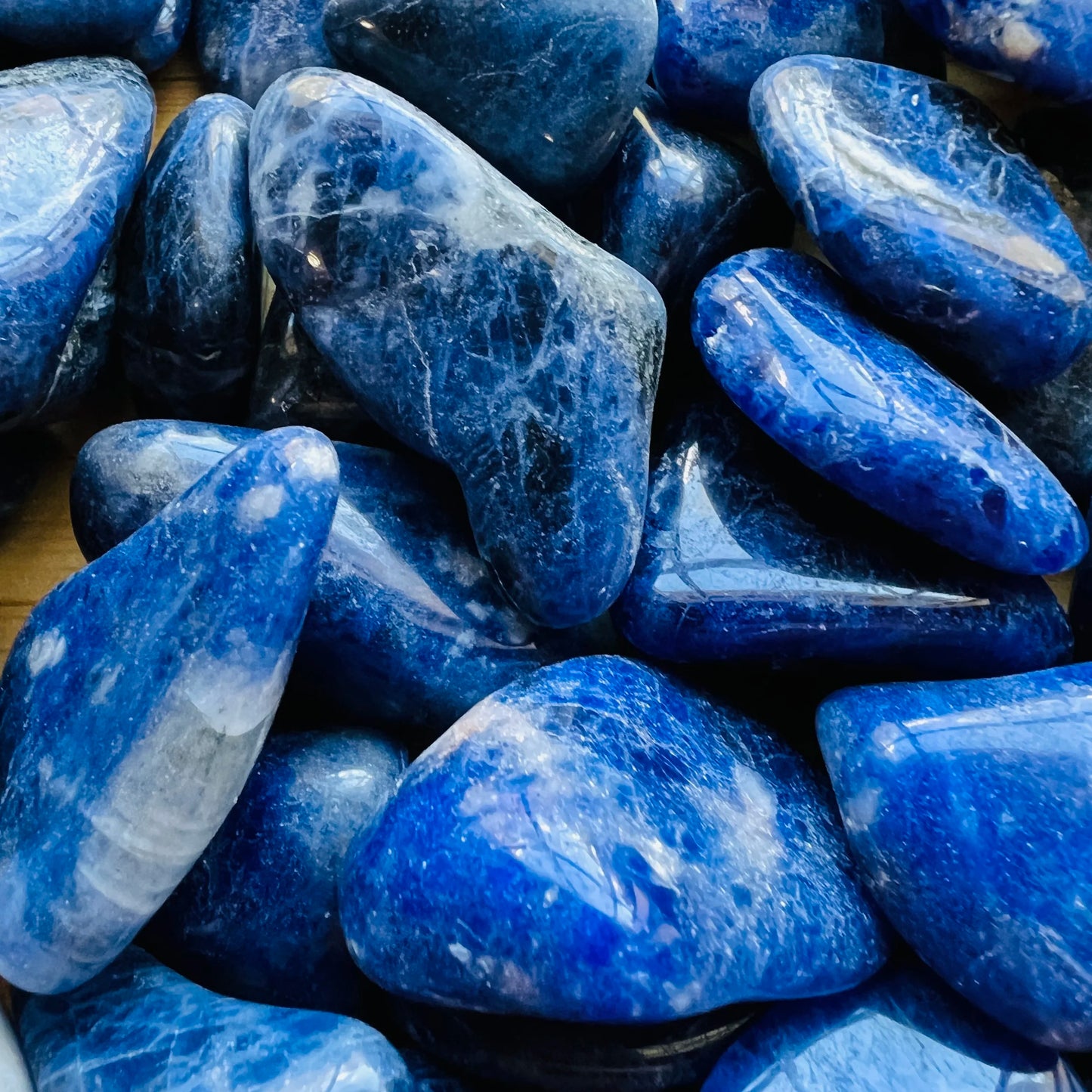 Underside detail of Sodalite tumbled stone, showing characteristic color.