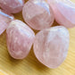Underside view of pink Rose Quartz palm stone, kept close for Love, sourced from Madagascar.