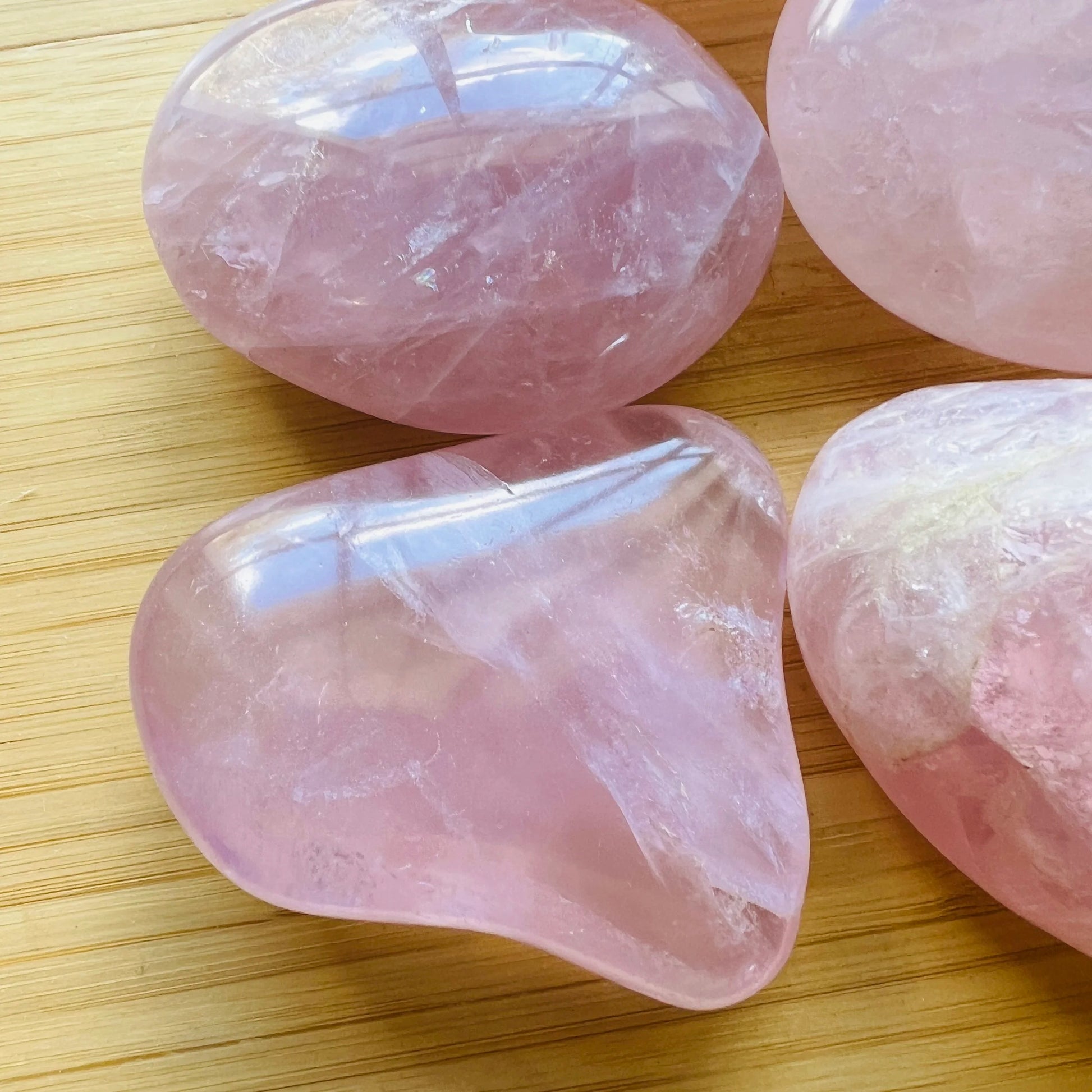 Size comparison with one Rose Quartz palm stone for scale, Madagascar-sourced.