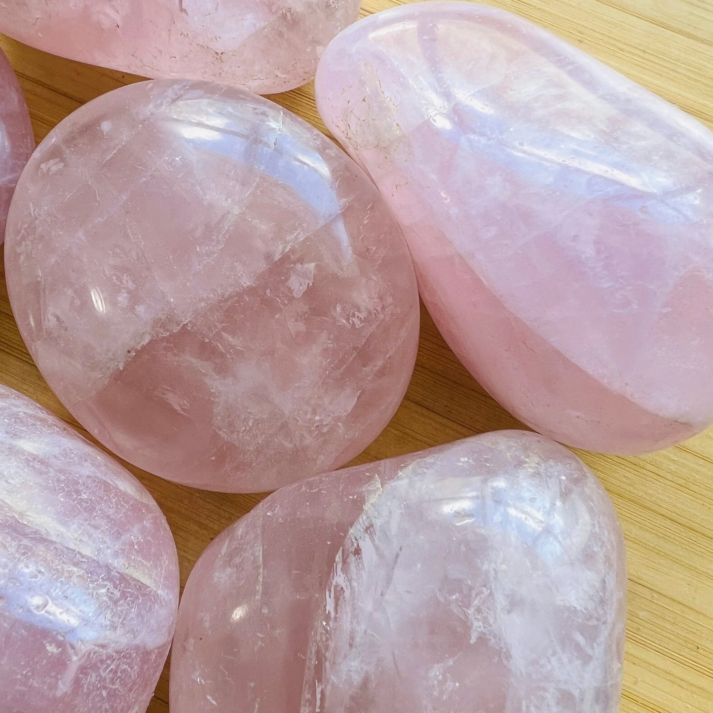 Back view of Grade AA Rose Quartz palm stone showing natural surface