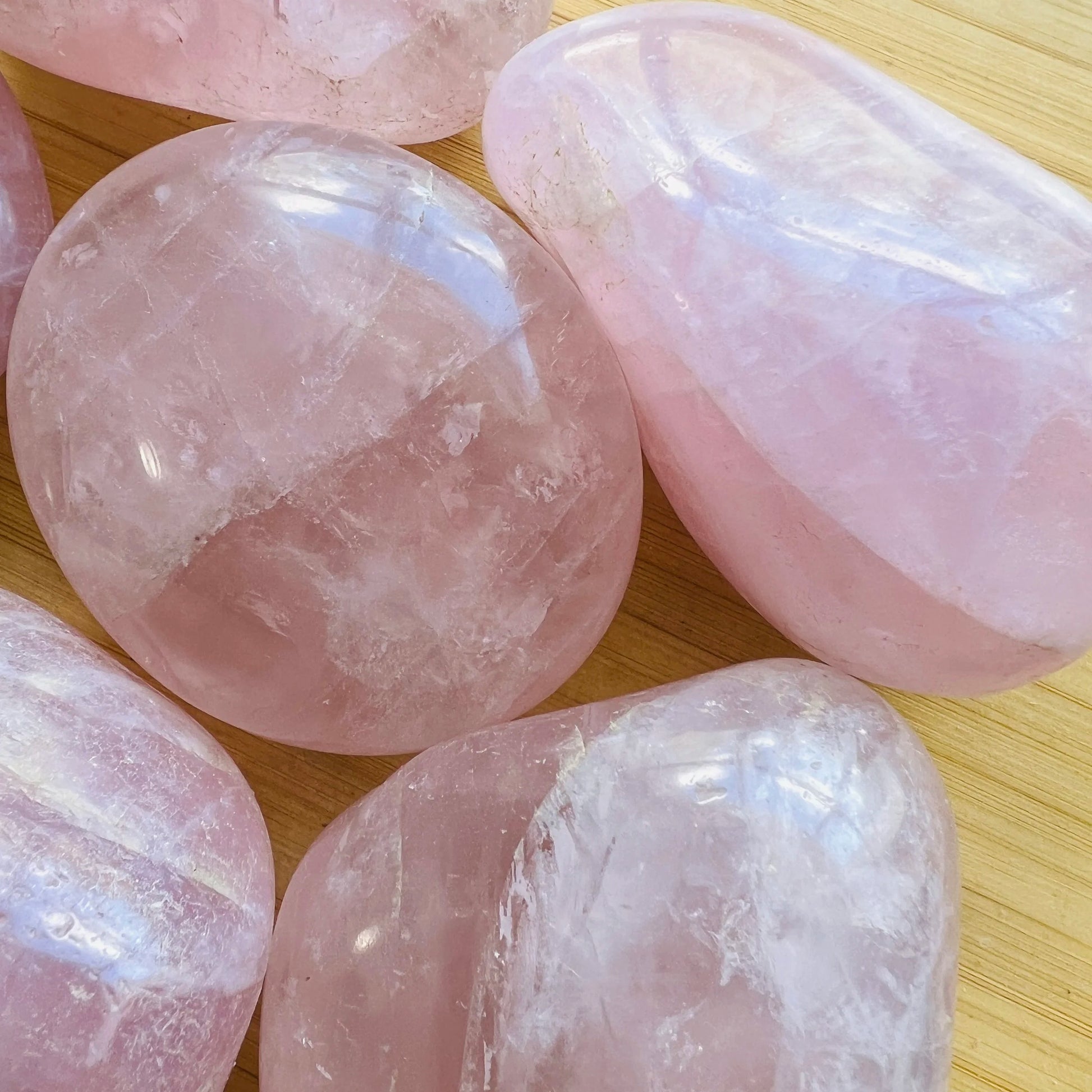 Back view of Grade AA Rose Quartz palm stone showing natural surface
