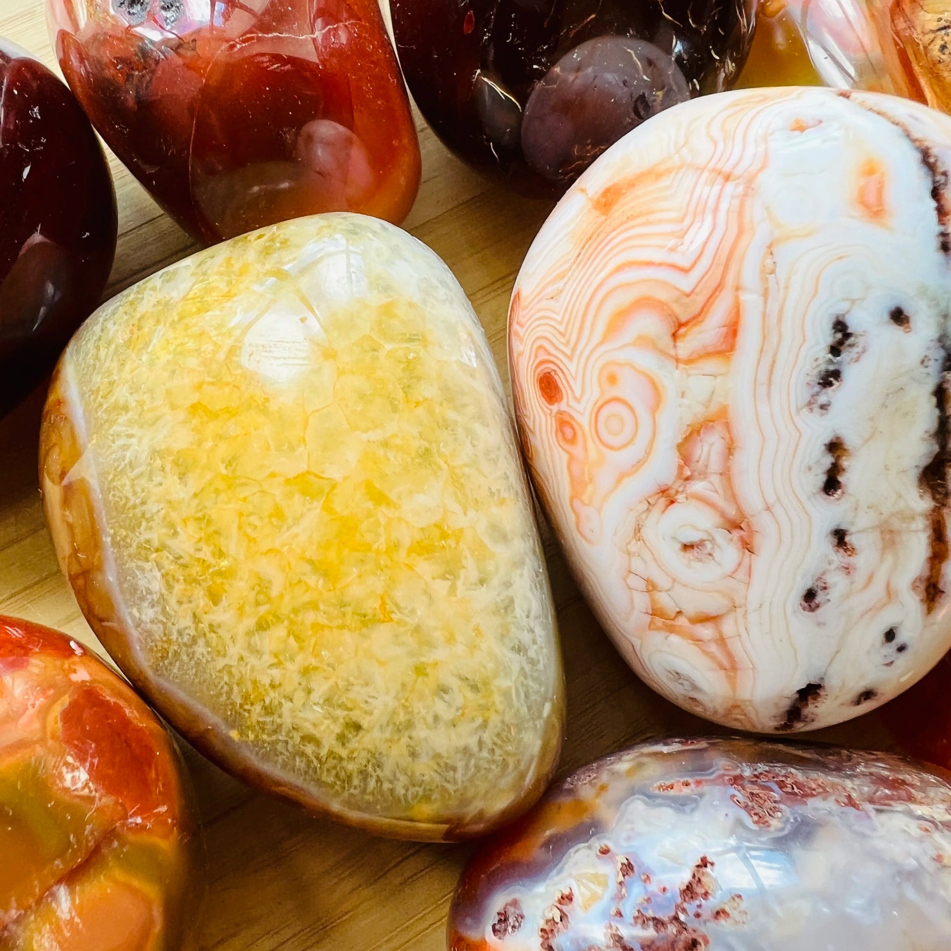 Side profile of Grade AA Carnelian palm stone with natural form and inclusions