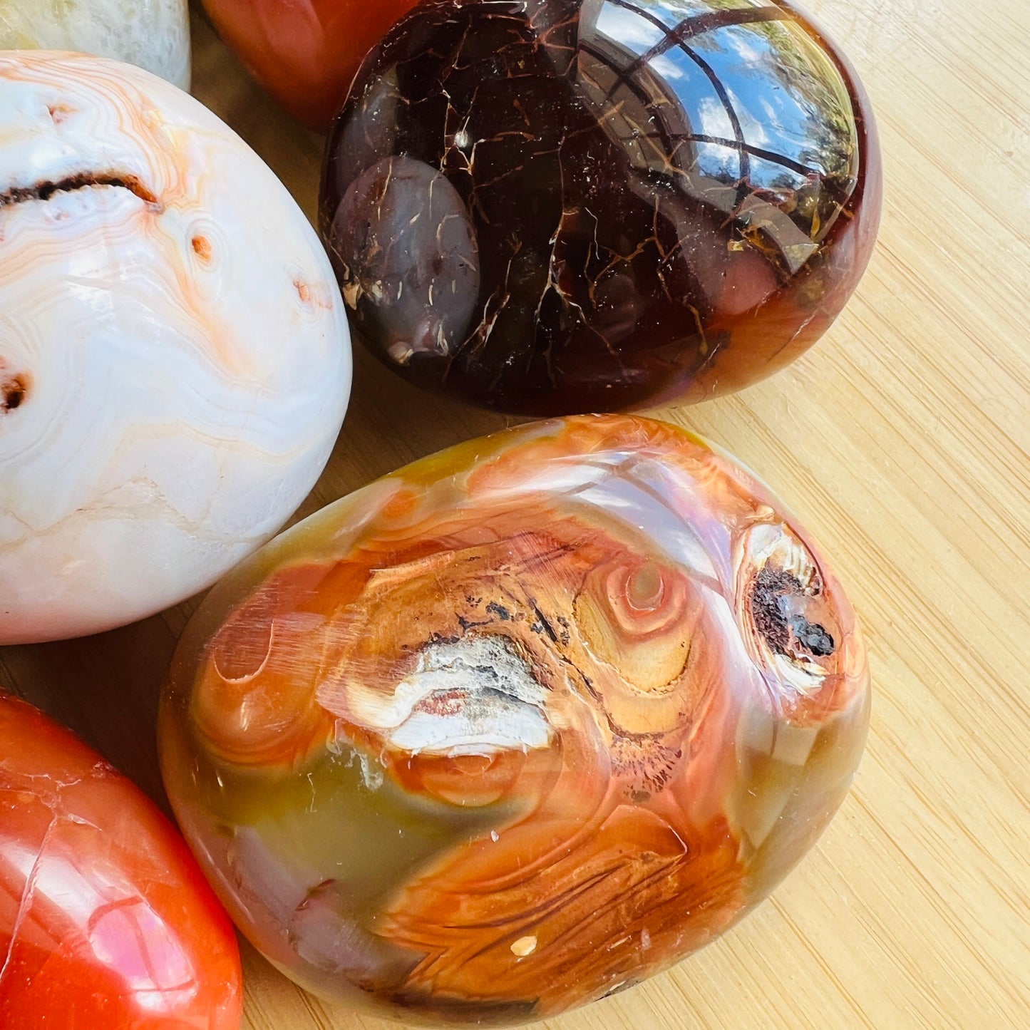 Alternate angle of Grade AA Carnelian palm stone showing overall shape