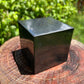 Lifestyle view of one Shungite polished cube for scale, from Russia.