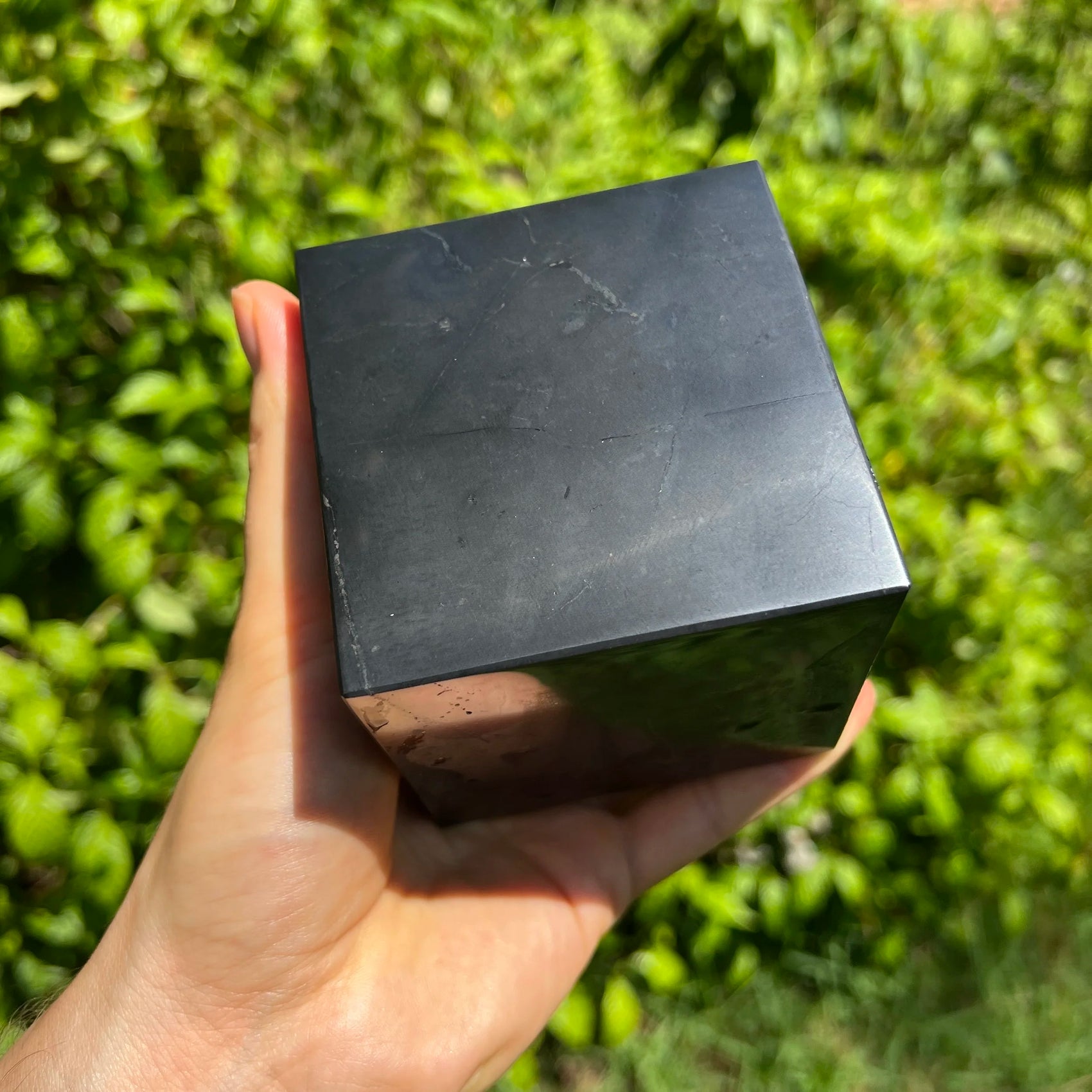 Back view of Grade Type III - Regular Grade Shungite polished crystals & decor showing natural surface