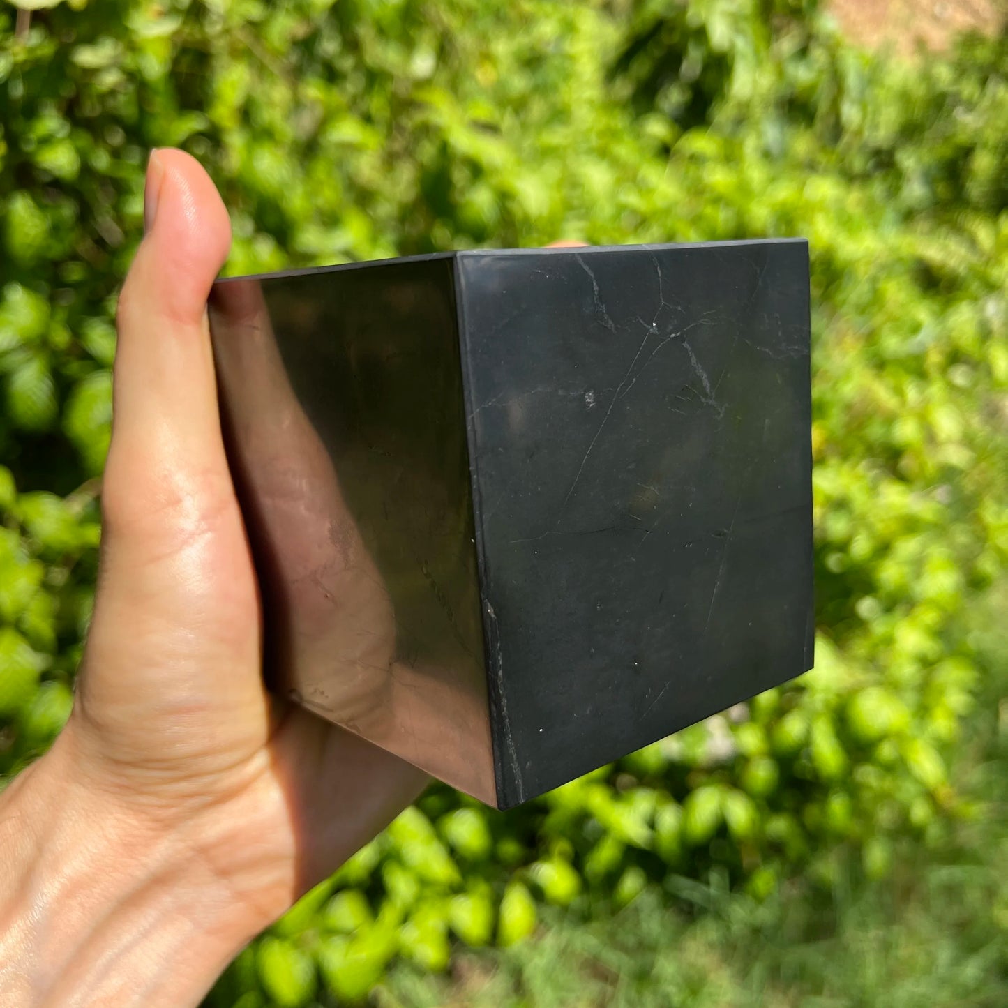 Detail shot of Grade Type III - Regular Grade Shungite polished crystals & decor under natural light