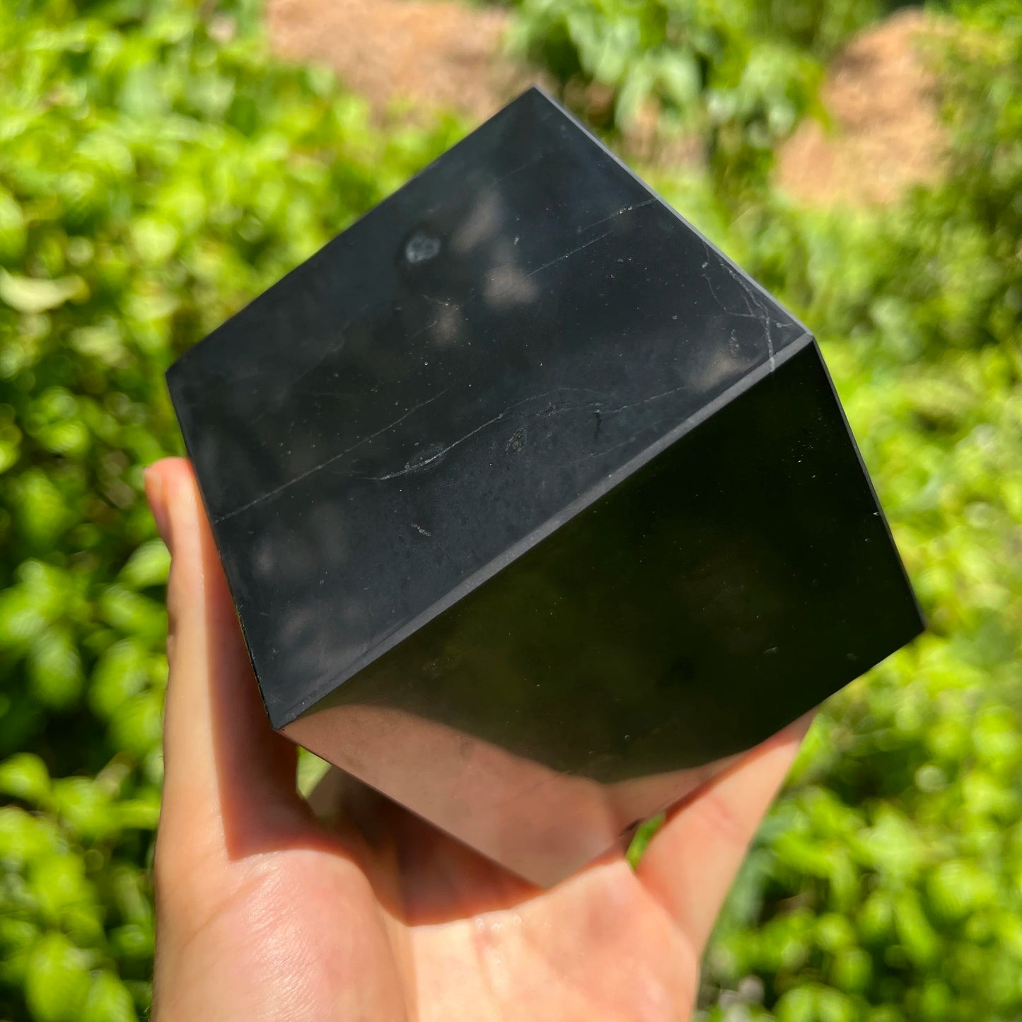 Grain detail of Shungite polished cube, traditionally used for Protection, from Republic of Karélia, Russia.