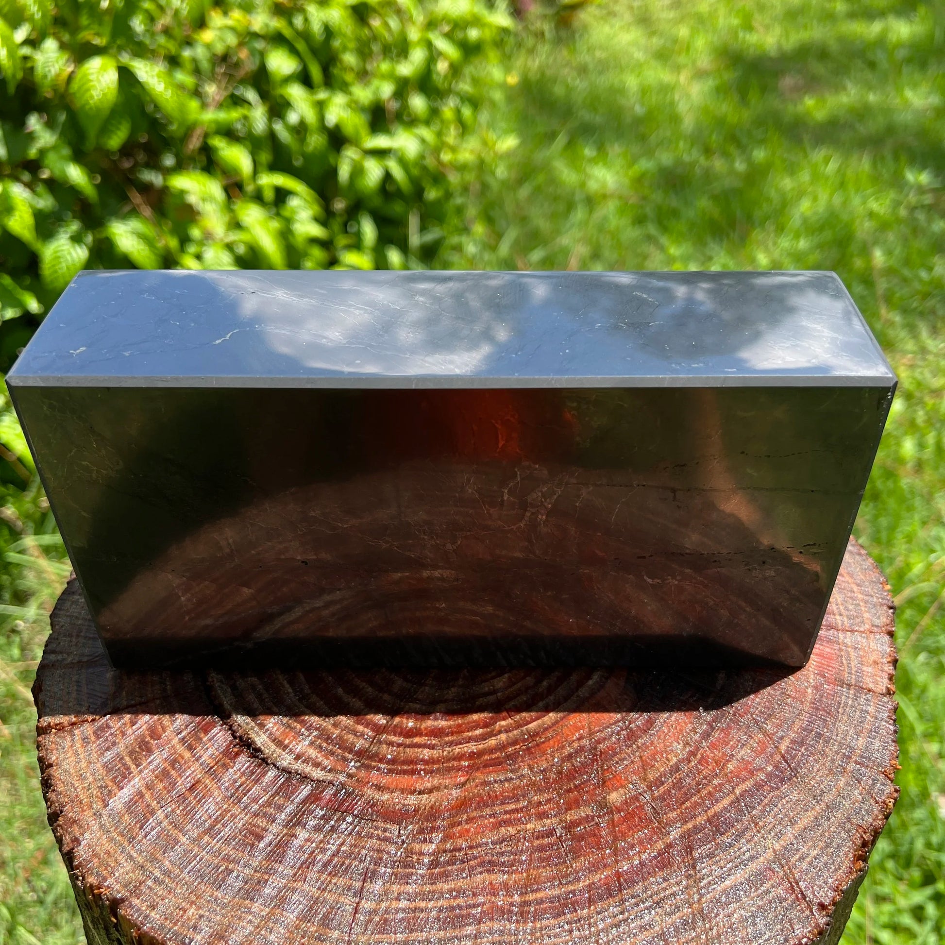 Top-down shot of Shungite polished block, traditionally used for Protection, sourced from Russia.