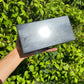 Size comparison with one Shungite polished block for scale, sourced from Republic of Karélia, Russia.