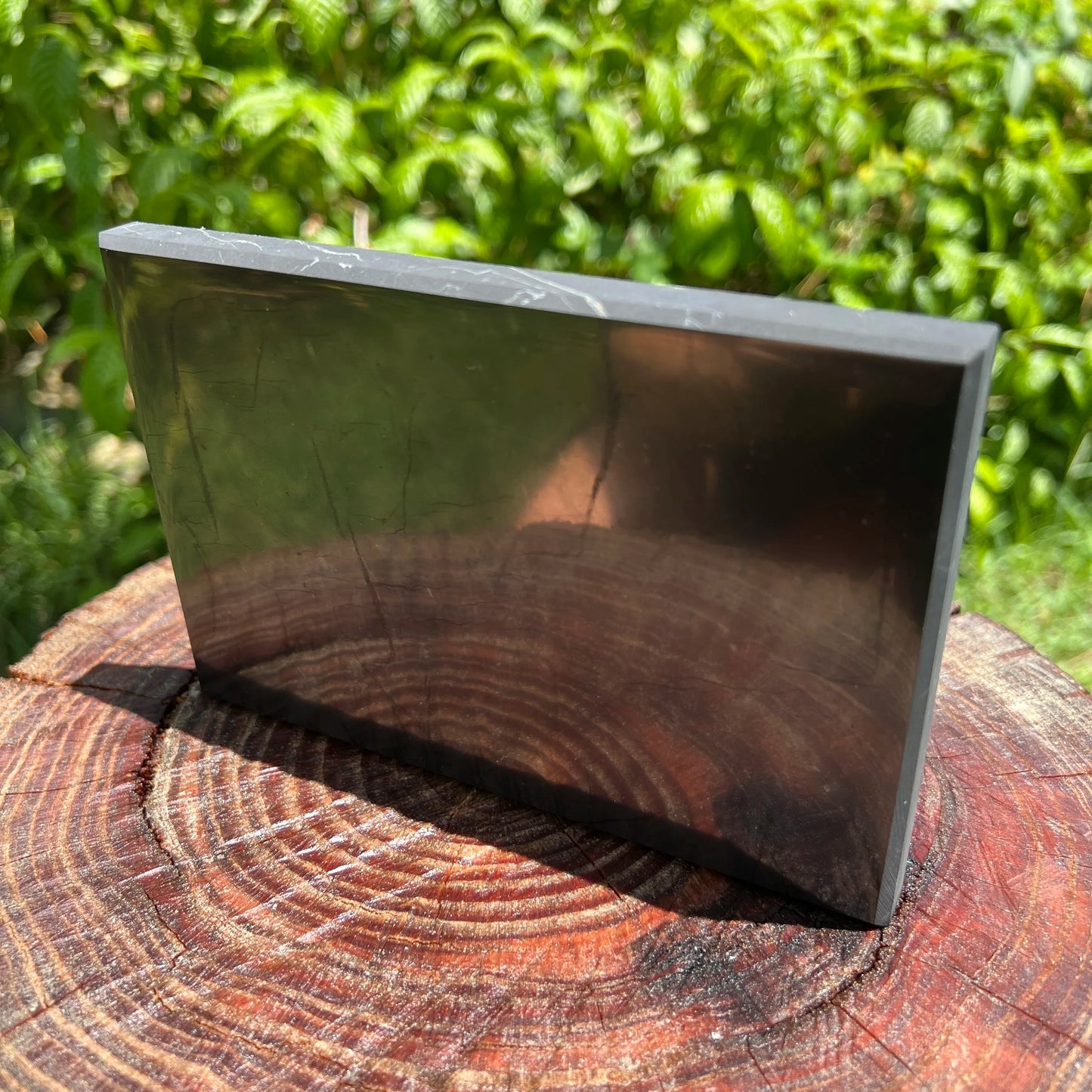 Profile shot of Shungite polished slab, showing translucent edges.