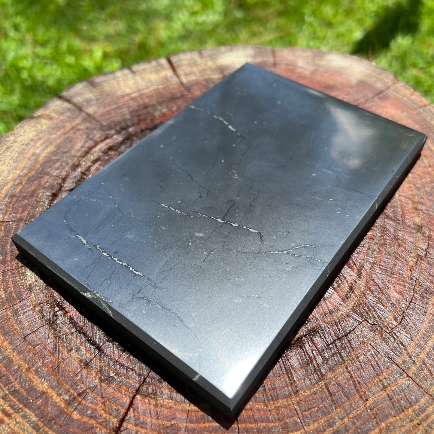 Top angle of Shungite polished slab, showing earthy tone, to support Protection.