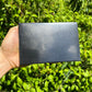Scale reference of a Shungite polished slab turned to for Protection and Cleansing, Russia-sourced.