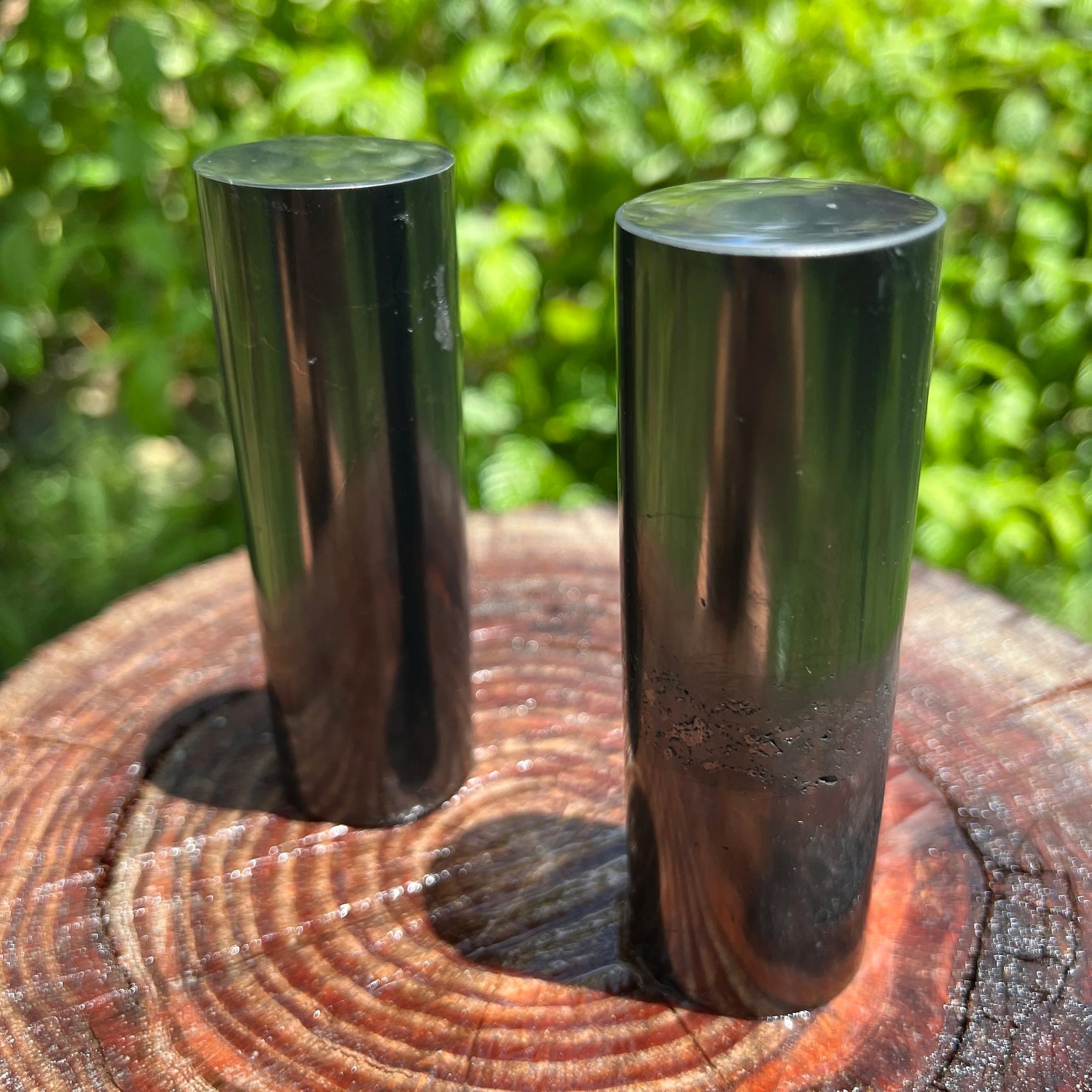 Macro view of Shungite polished cylinder, showing translucent edges.
