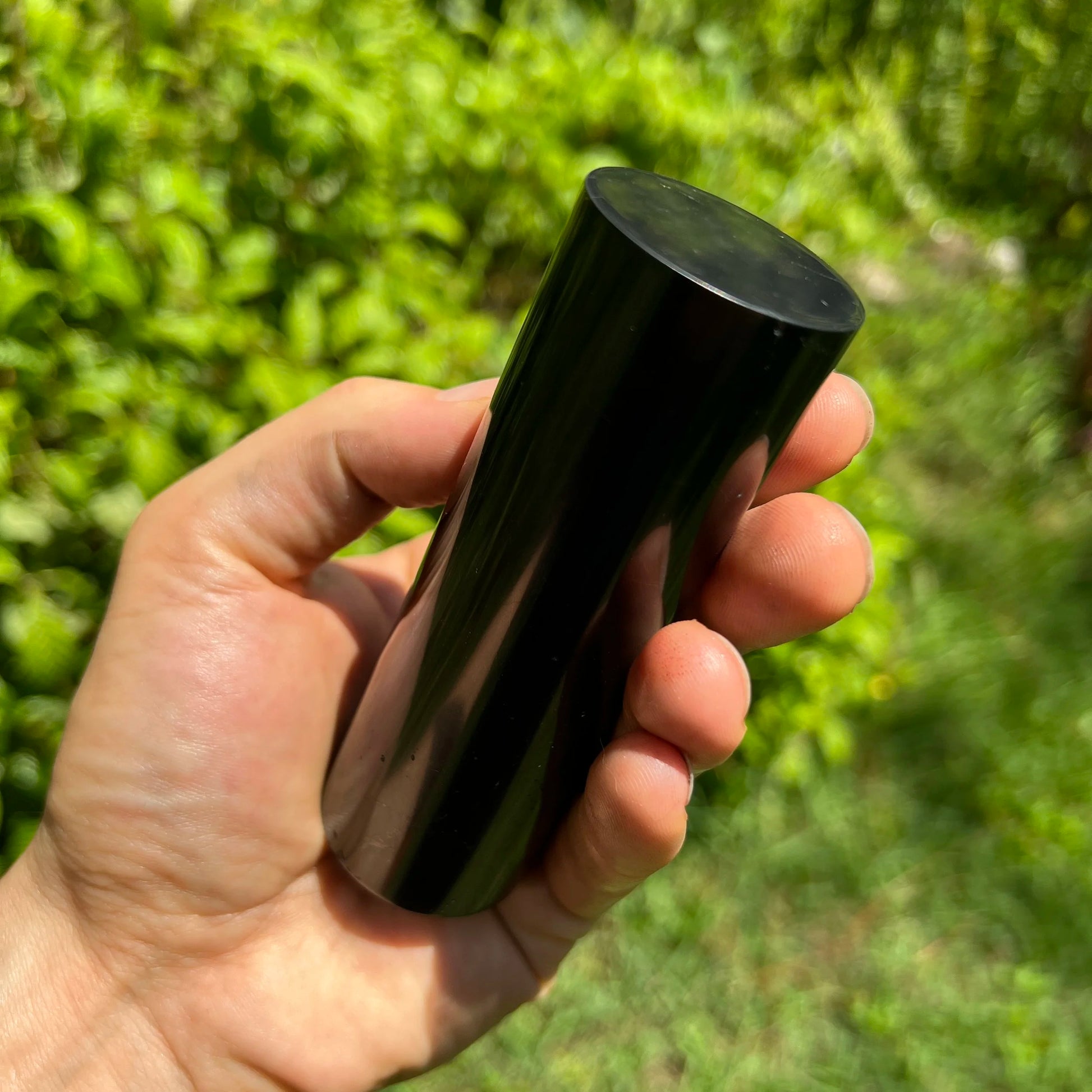 Size comparison with a single Shungite polished cylinder sourced from Russia.