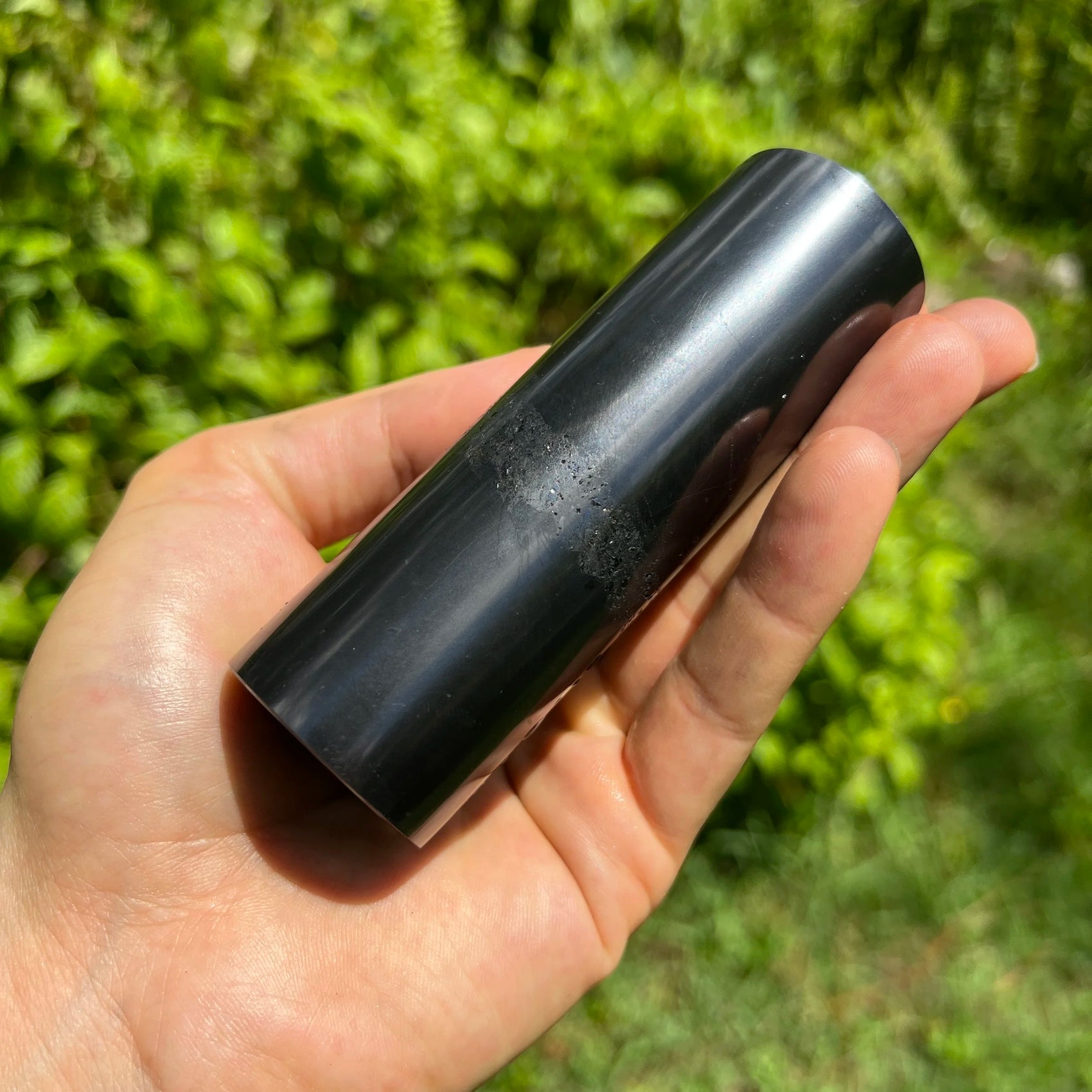 Holding a Shungite stone, from Republic of Karélia, Russia, with surface texture in view.