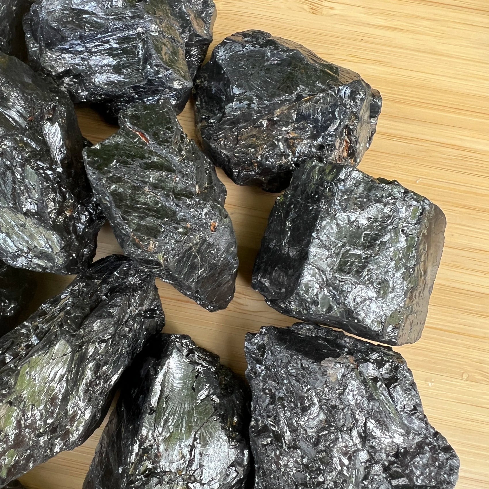 Reverse side of Shungite raw stone, showing natural texture, associated with Protection.