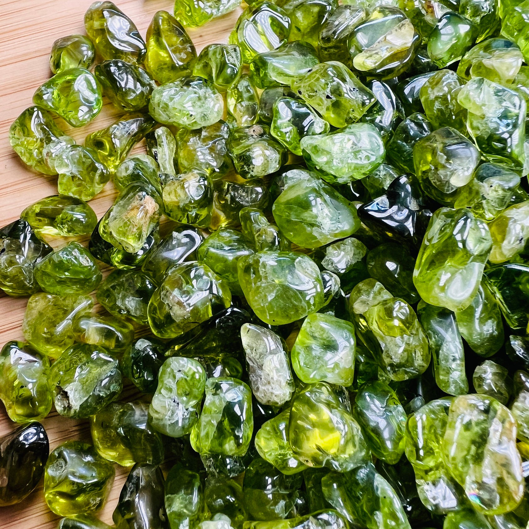Sideways view of green Peridot tumbled stone, carried for Abundance and Emotional Healing, hand-selected from San Carlos Apache.