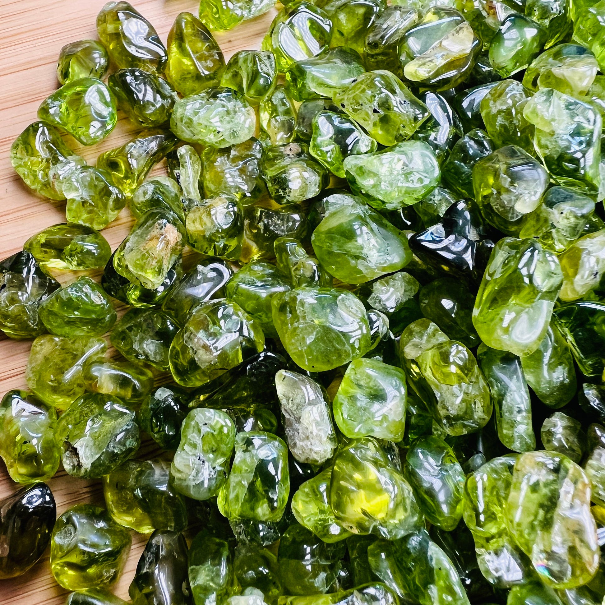 Sideways view of green Peridot tumbled stone, carried for Abundance and Emotional Healing, hand-selected from San Carlos Apache.