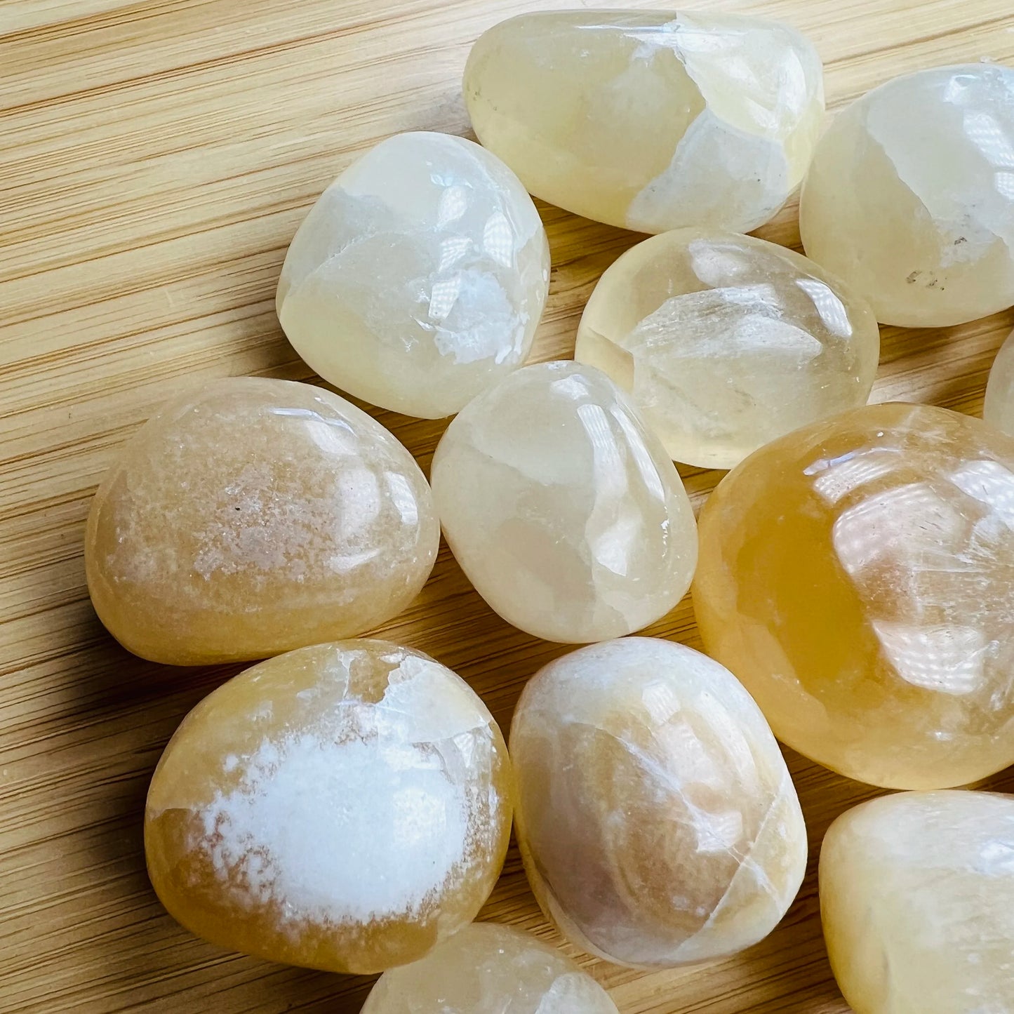 Plan view of Grade AA Honey Calcite tumbled stone, turned to for Confidence, showing soft luster.