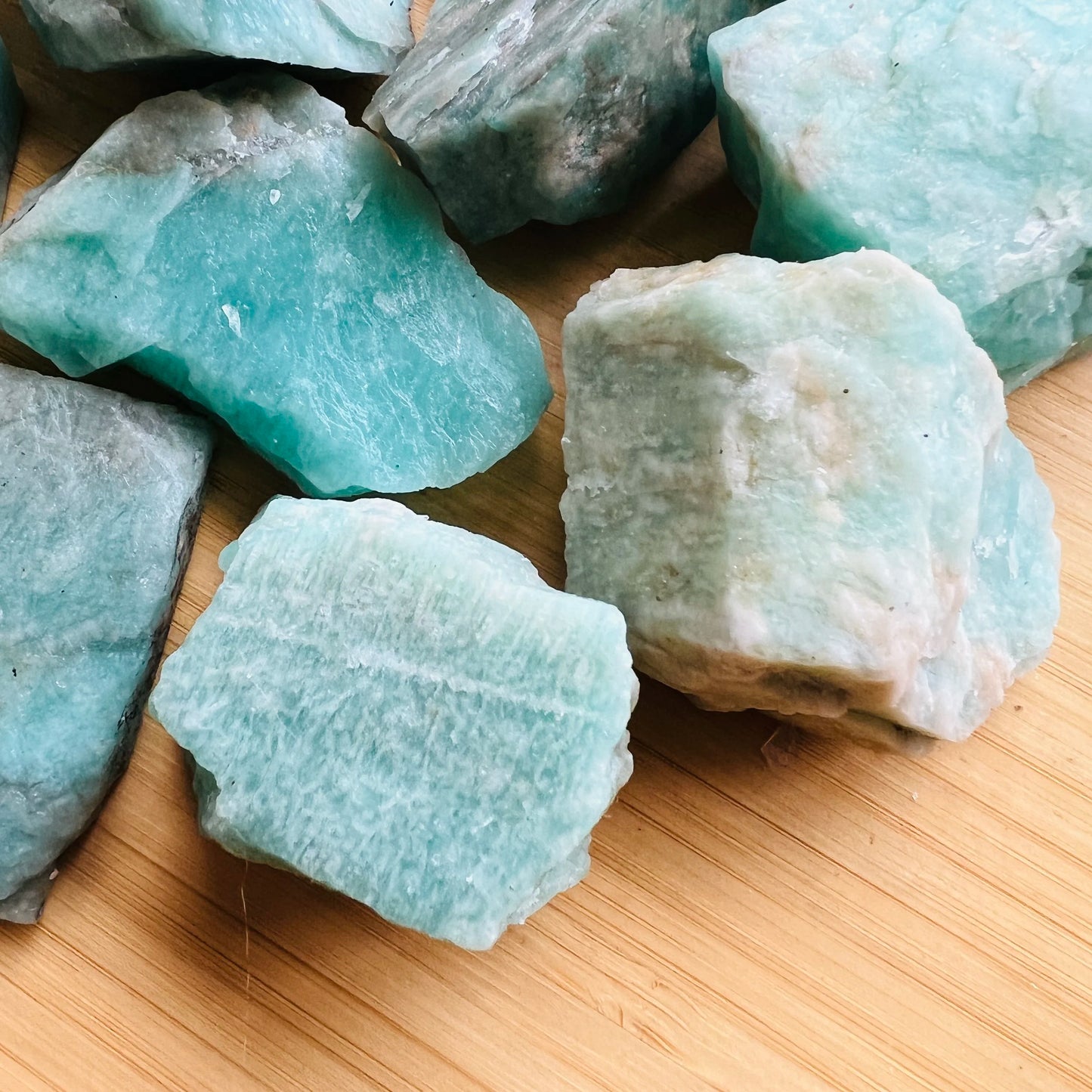 Edge view of Grade A Amazonite raw stone, showing natural inclusions.