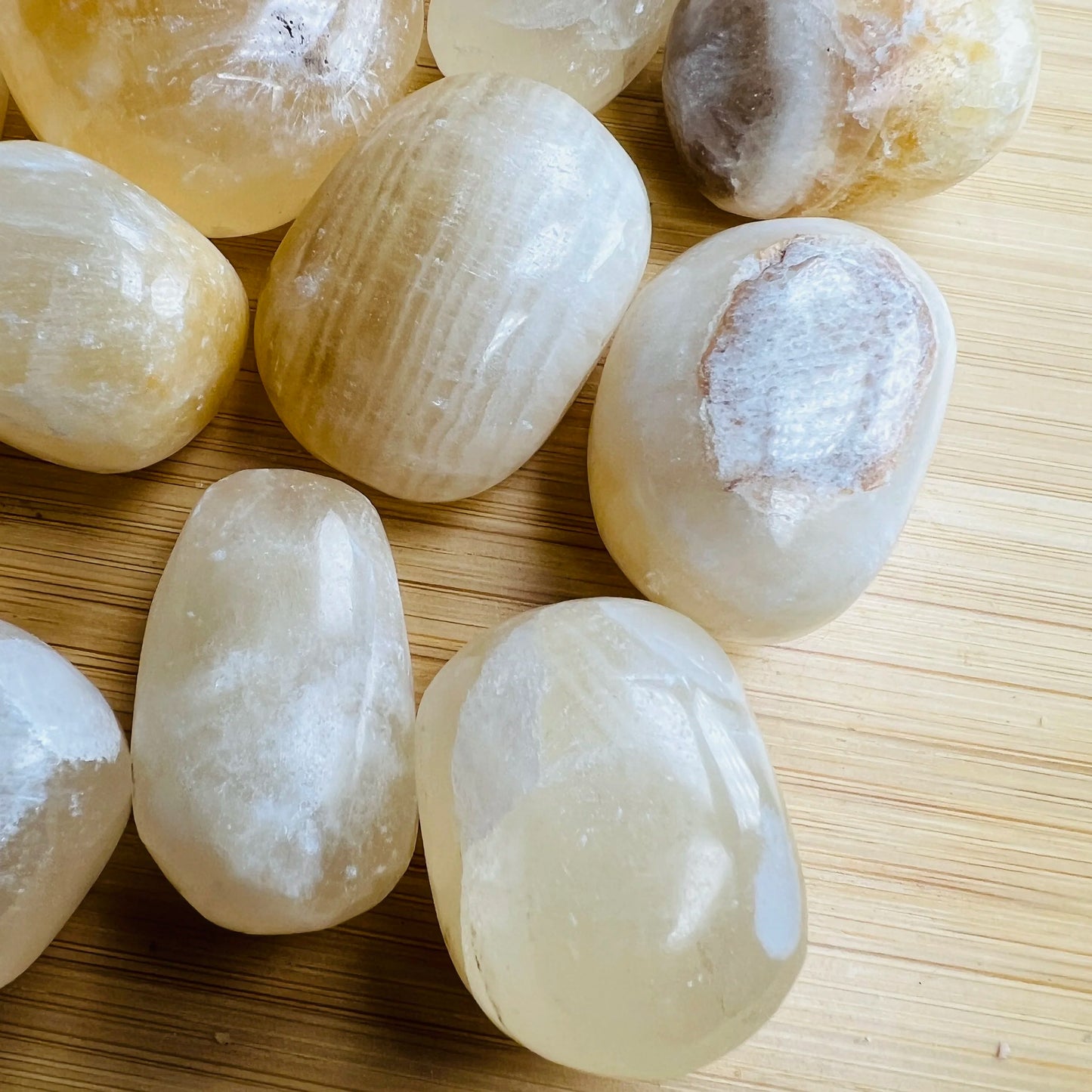 Bottom side of Honey Calcite tumbled stone, showing color depth.